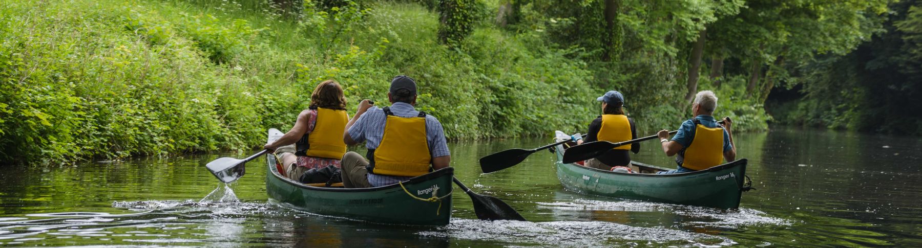 a group of people canoeing